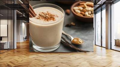 Delicious peanut butter smoothie decorated with cinnamon sticks and nuts Wall mural