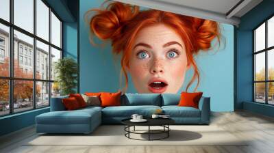 Portrait of shocked beautiful redhead woman posing on blue background showing surprised face expression Wall mural