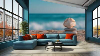 Seashell balancing on rocks on the beach with ocean waves in background Wall mural