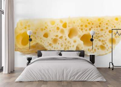 Slice of swiss cheese with many holes is lying on white background Wall mural