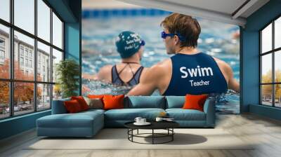 Swim teacher supervising students during lesson in swimming pool Wall mural