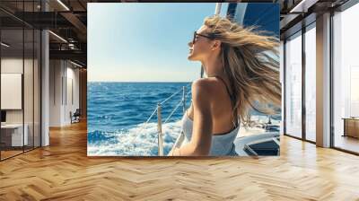 Woman enjoying sailing on yacht on summer vacation Wall mural