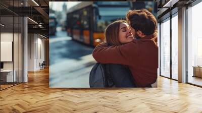 Young couple hugging at the bus station after traveling Wall mural