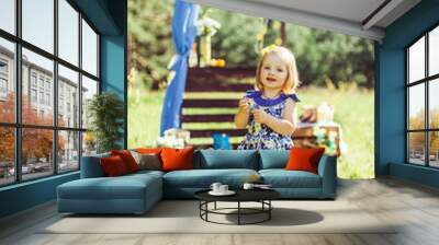 Happy positive baby girl playing outdoors in summer  garden. Childhood, healthy lifestyle, happiness concept Wall mural