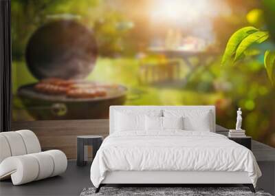 summer time in backyard garden with grill BBQ, wooden table, blurred background Wall mural