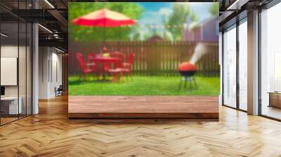 summer time in backyard garden with grill BBQ, wooden table, blurred background Wall mural