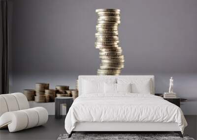 A tall stack of coins sways precariously, symbolizing the instability and risk of financial success.  Smaller stacks surround it, highlighting the accumulation of wealth over time. Wall mural