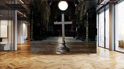 A view of a cross on a wooden table in a church Wall mural