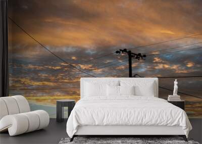 Silhouette of a power lines in Lightning Ridge back lit by a sunset Wall mural