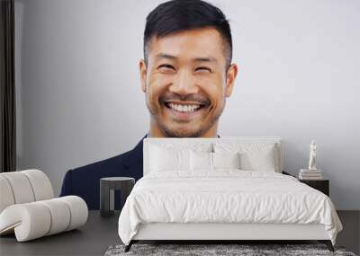 Each success brings a smile to my face. Studio portrait of a handsome young man posing against a grey background. Wall mural