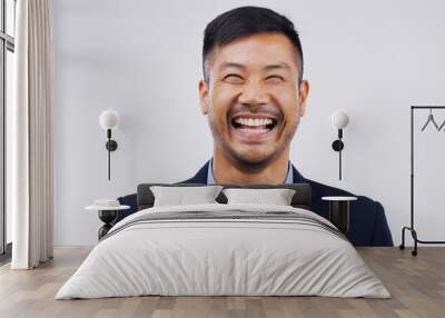 Happy, laughing and portrait of businessman in a studio with comedy, comic joke or funny story. Happiness, smile and face of an Asian male person with a positive face expression by gray background. Wall mural