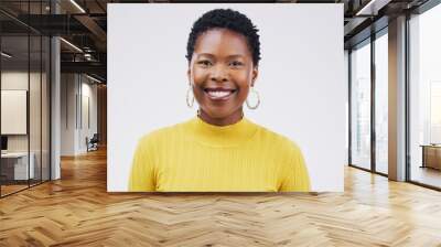 Happy, smile and portrait of a black woman with a headshot isolated on a white background in a studio. Happiness, business and face of a young African employee smiling for a corporate profile Wall mural