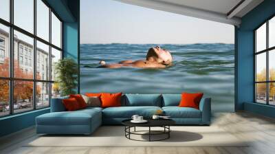 man floating on water Wall mural