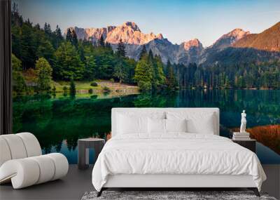 calm morning view of fusine lake. colorful summer sunrise in julian alps with mangart peak on backgr Wall mural