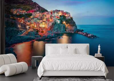 Colorful evening cityscape of Manarola, second city of Cique Terre sequence of hill cities. Dark summer scene of Liguria, Italy, Europe. Splendid seascape of Mediterranean sea. Wall mural