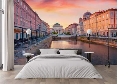 Spectacular summer sunrise in Trieste, Italy, Europe. Gorgeous morning view of Canal Grande di Trieste and Church of Sant'Antonio Nuovo on background. Traveling concept background. Wall mural