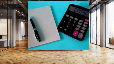 Notepad, pen, stethoscope on a blue background.The concept of medicine. the word crisis on a calculator, Notepad and pen on a blue background.The concept of crisis Wall mural