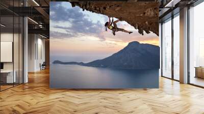 Young female rock climber at sunset, Kalymnos Island, Greece Wall mural