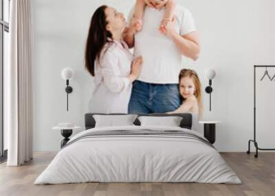 beautiful happy family at a photo shoot in a white photo studio. backstage. Wall mural