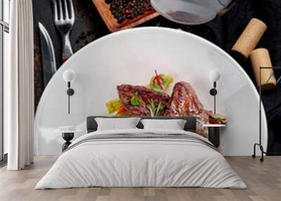 Beef liver stewed with demiglas sauce and served with vegetables on a white plate. Wall mural