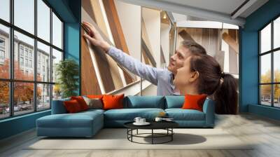 Couple looking at parquet board for home flooring in store Wall mural