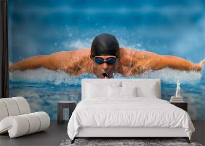 Man in swimming pool. Butterfly style Wall mural