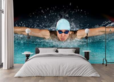 Man in swimming pool. Butterfly style Wall mural