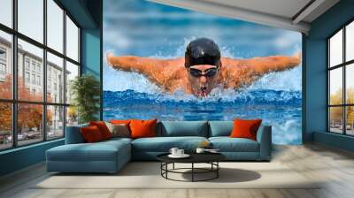 Man in swimming pool. Butterfly style Wall mural