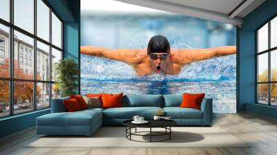 Man in swimming pool. Butterfly style Wall mural