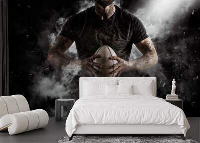 Rugby player in action on dark Wall mural