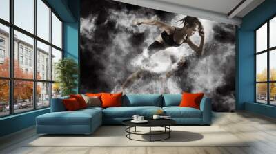 Woman sprinter leaving starting Wall mural