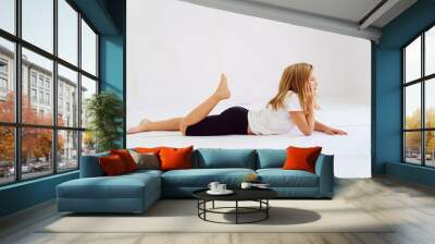 Cheerful teenage girl in white t-shirt and black breeches on white background Wall mural