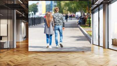 couple is walking along the embankment in the city Wall mural