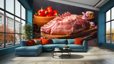 Raw meat with herbs and spices on dark background. Raw pork steak. Ingredients for cooking meat Wall mural