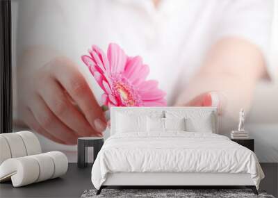 Woman hygiene conception. Pink flower gerbera in female hands Wall mural