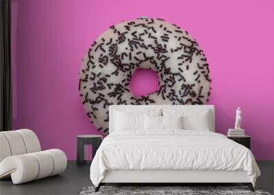 Donuts with icing on pastel pink background. Sweet donuts. Wall mural