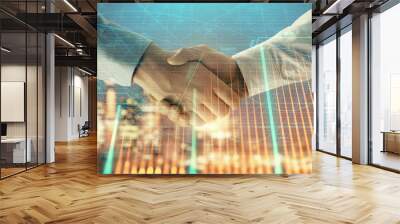 Double exposure of financial chart on cityscape background with two businessmen handshake. Concept of financial analysis and investment opportunities Wall mural