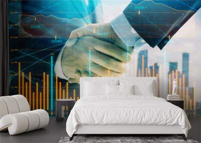 Double exposure of financial graph on cityscape background with two businessman handshake. Concept of stock market deal Wall mural