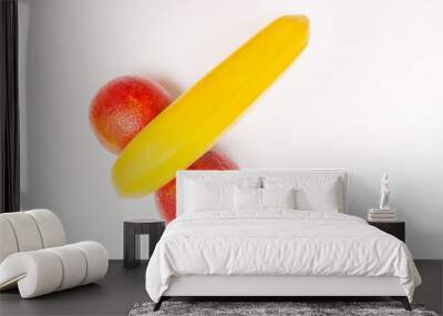 Funny concept of fruit, banana and two red oranges isolated on white background Wall mural