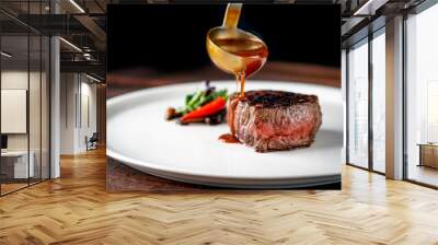 Grilled beef tenderloin steak on a white platter is served with demiglas sauce Wall mural