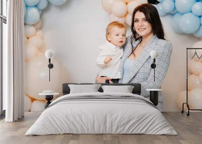 happy mom and son in front of the photo zone with balloons Wall mural