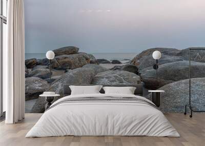 beautiful coastal stones on the shore of the warm sea in summer Wall mural