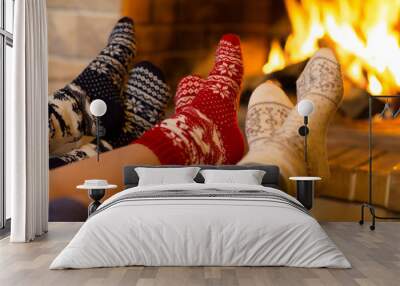 Family in socks near fireplace in winter or christmas time Wall mural