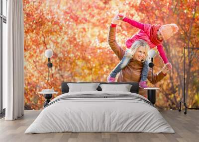 Happy mother and kid having fun together outdoor in autumn or fa Wall mural