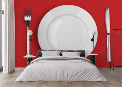 knife, white plate and fork on red background Wall mural