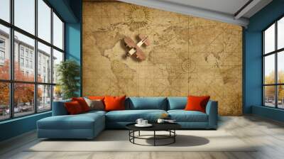 Small wood airplane over world nautical map as travel, explore and communication concept Wall mural