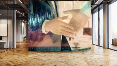 Multi exposure of financial graph on office background with two businessmen handshake. Concept of success in business Wall mural