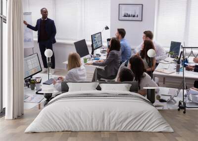 An African Businessman Giving Presentation To His Colleagues Wall mural