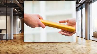 Businessman Giving Relay Baton To Colleague Wall mural