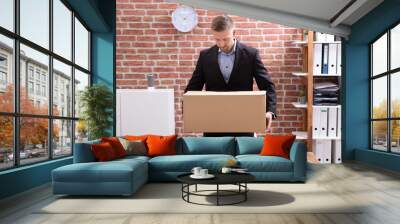 Businessman Packing His Belongings In Cardboard Box Wall mural